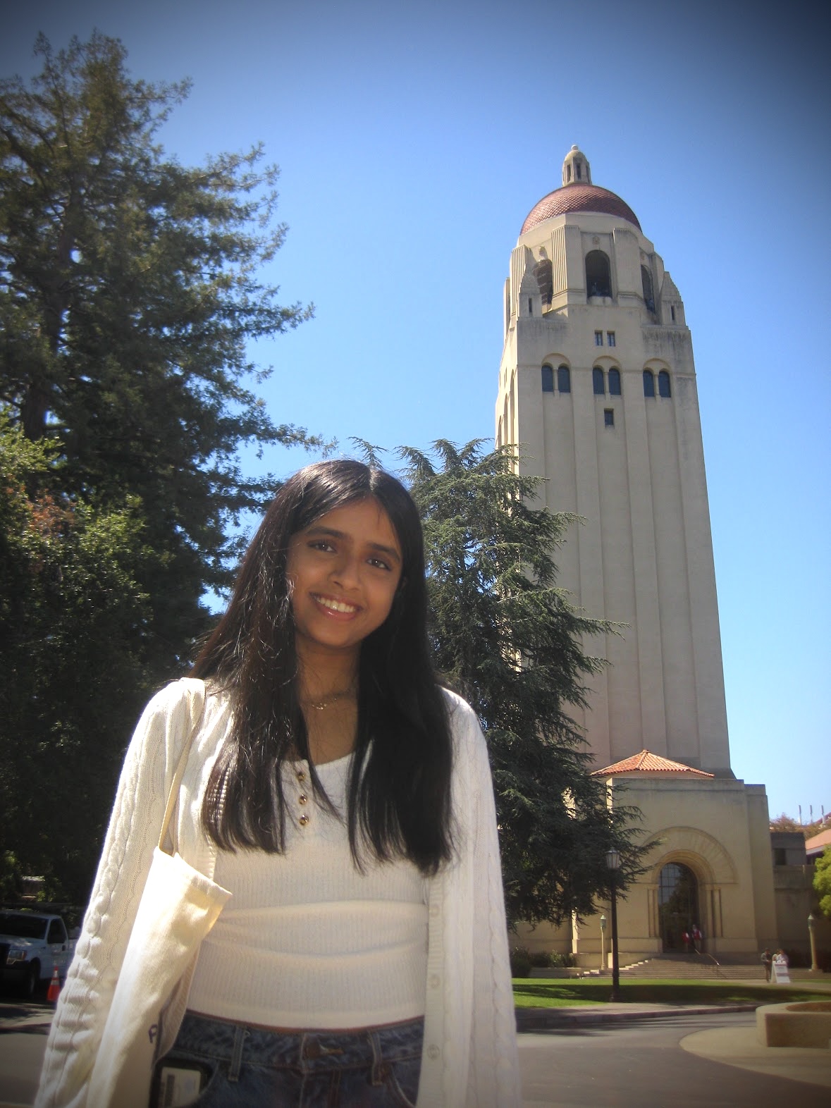 Shanza standing before Hoover Tower at Stanford